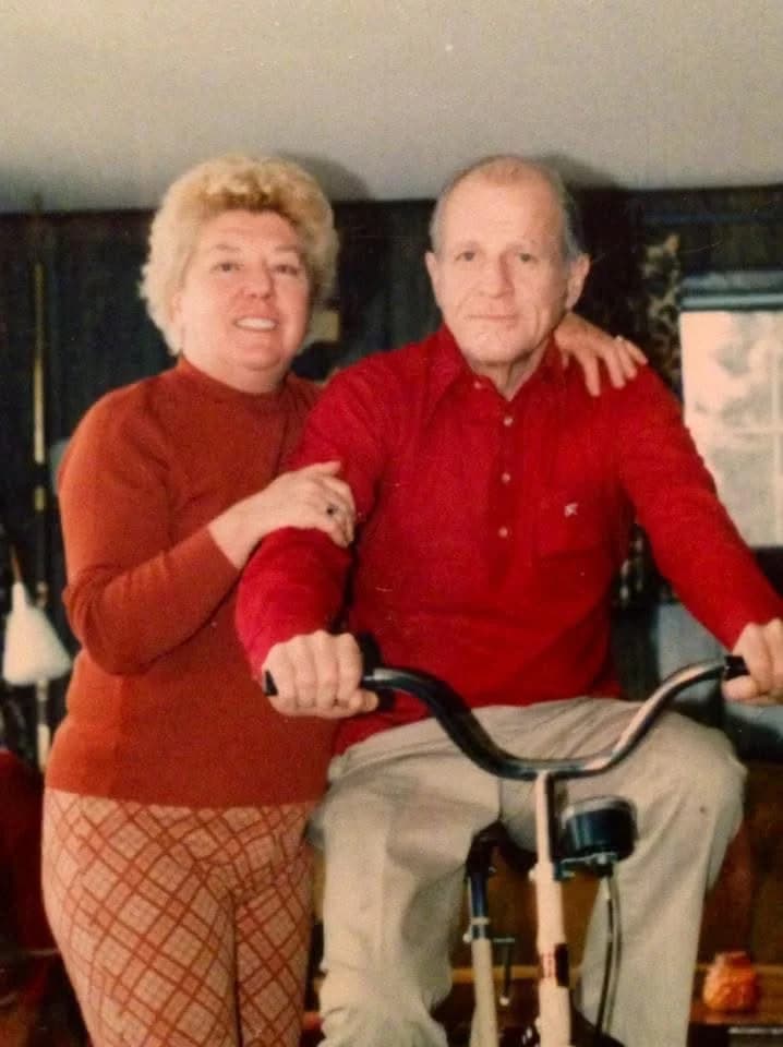 Clare Coogan Long and Rep. John J. Long on a stationary bike