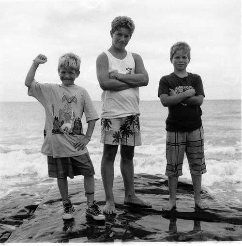 The three Long brothers — John, Perry, and Patrick — together on rocks