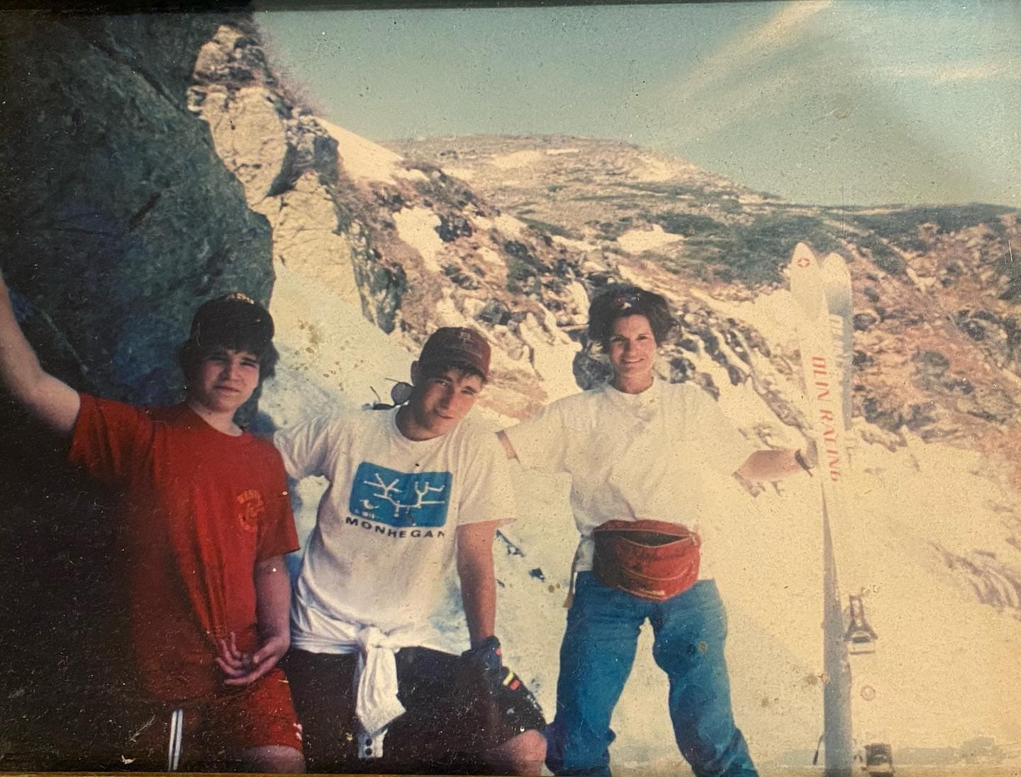 Three teens on a mountain summit