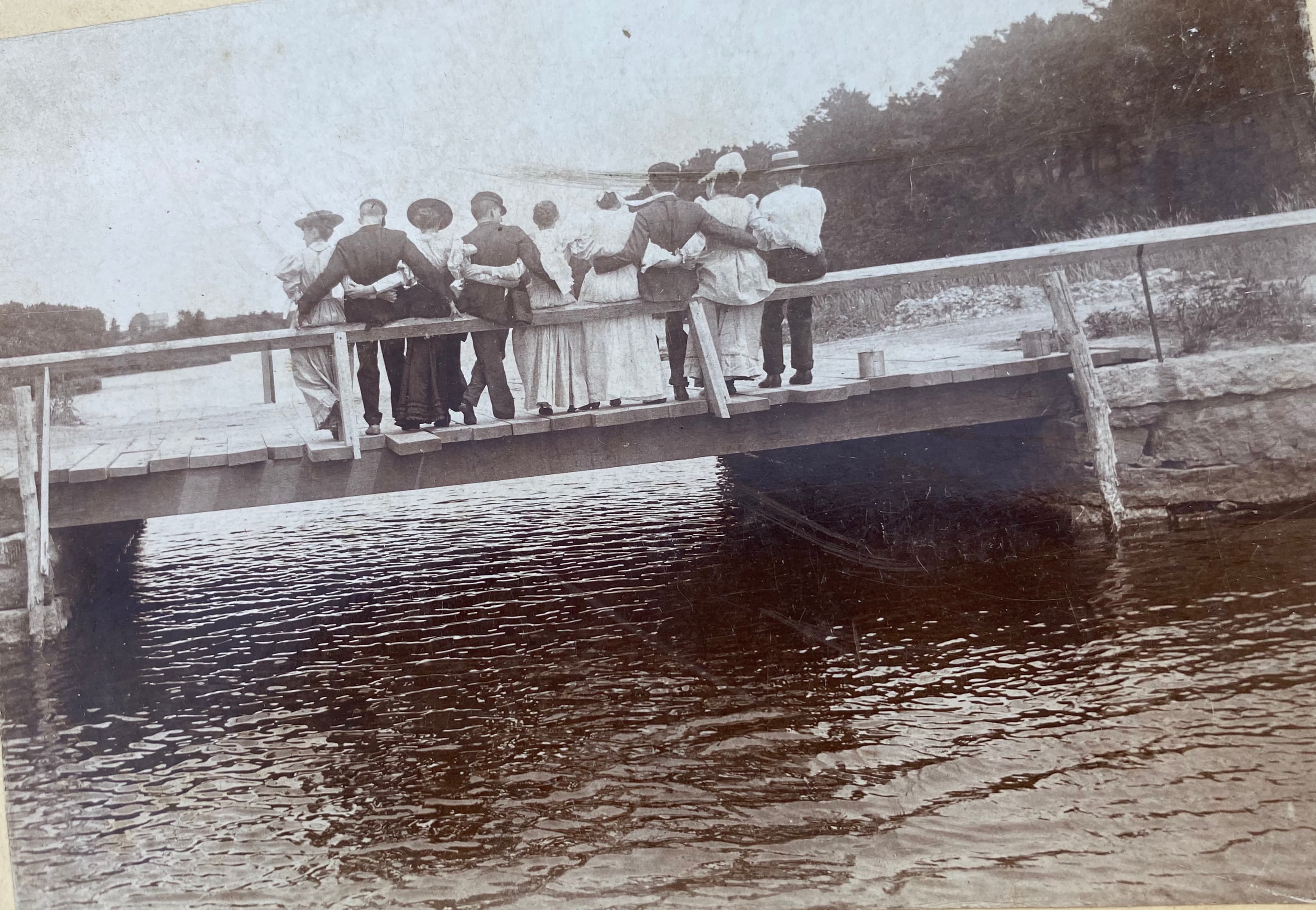 Group on bridge, backs turned, Childs River